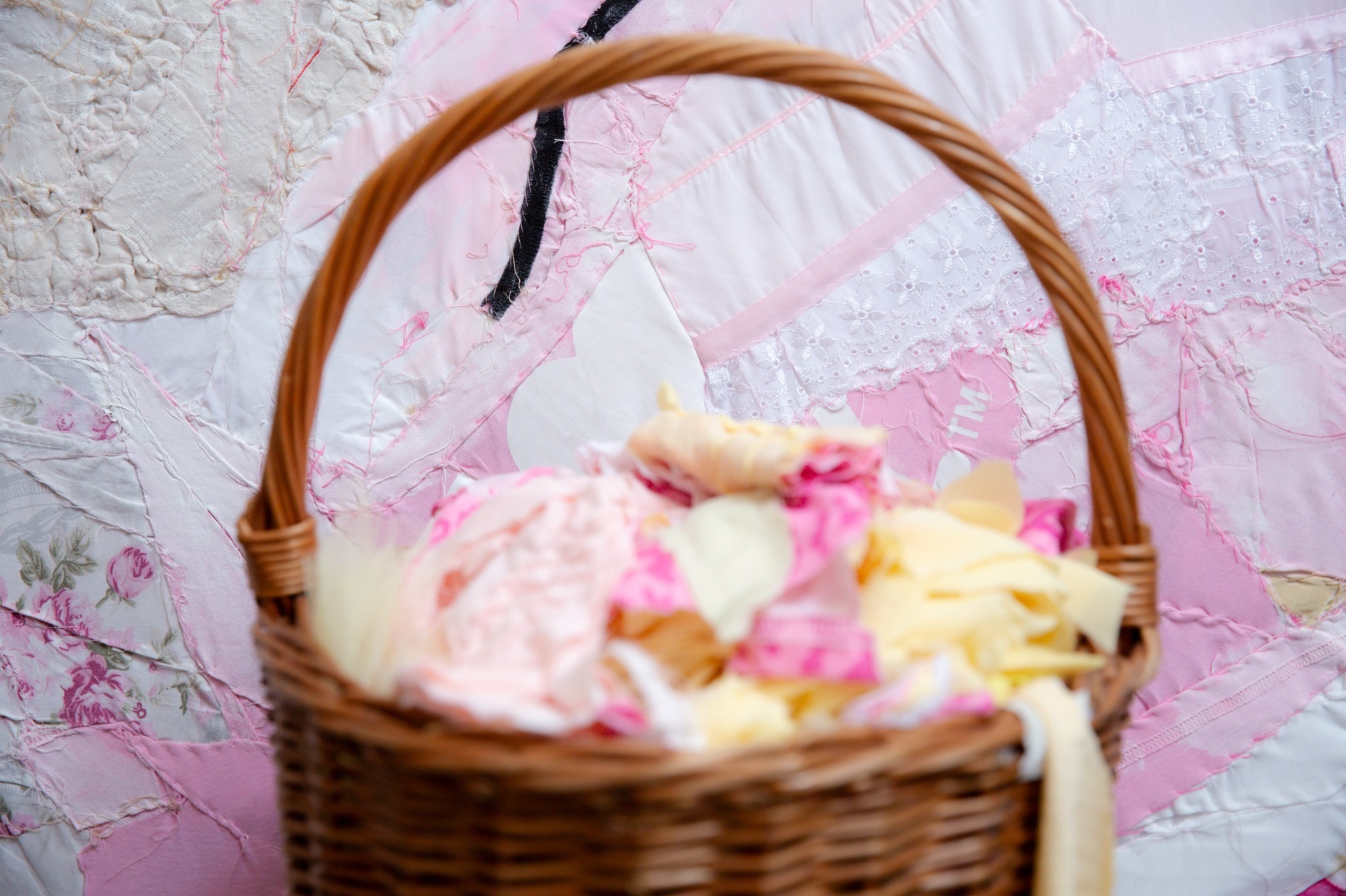 Basket of fabric pieces in front of a pink textile work in Hannah Maria Schmutterer’s studio